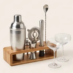 A steel cocktail making set with two coupe glasses