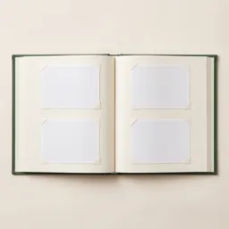 An open linen photo album with blank photo pages