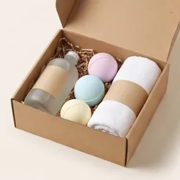 A bath gift set with bottles, bath bombs and a towel