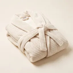 A folded plush cream dressing gown