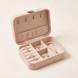 An open velvet jewellery box with rings and a necklace