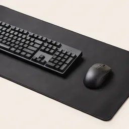 A large desk mouse mat under a keyboard