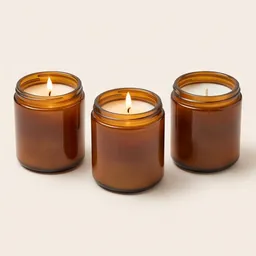 Scented candles in amber jars