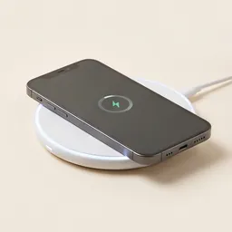 A wireless charging pad with a phone